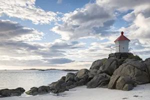 The lighthouse on cliffs surrounded by sea during Midnight sun, Eggum Unstad, Vestvagoy The lighthouse on cliffs surrounded by sea during Midnight sun, Eggum Unstad, Vestvagoy