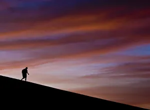 Lone figure on dune, Erg Chigaga, Sahara Desert, Morocco, Africa Lone figure on dune, Erg Chigaga, Sahara Desert, Morocco, Africa
