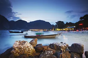 Long tail boats on Ao Ton Sai beach at dusk, Ko Phi Phi Don, Thailand Long tail boats on Ao Ton Sai beach at dusk, Ko Phi Phi Don, Thailand
