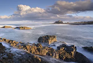 Looking across rocky ledges to Bamburgh Castle, Northumberland, England Looking across rocky ledges to Bamburgh Castle, Northumberland, England
