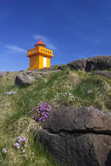 Low angle view of lighthouse on cliff at Djupivogur, East Iceland, Iceland Low angle view of lighthouse on cliff at Djupivogur, East Iceland, Iceland