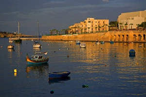 Malta, Europe; Colourful traditional wooden boats in the placid bay of the former fishing village Malta, Europe; Colourful traditional wooden boats in the placid bay of the former fishing village