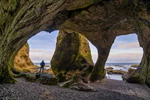 Man in Cathedral Cave, Co. Antrim, Northern Ireland Man in Cathedral Cave, Co. Antrim, Northern Ireland