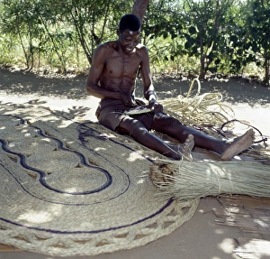 A man makes attractive floor mats from dried palm fronds near Liwonde A man makes attractive floor mats from dried palm fronds near Liwonde
