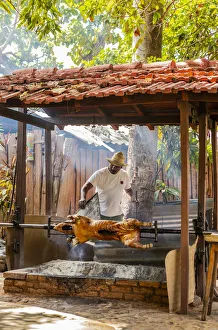 A man roasting a pig in a restaurant in Trinidad, Sancti Spiritus, Cuba