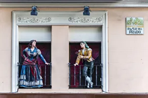 Man and woman sculptures with traditional Spanish dressed on the balconies, Paseo Man and woman sculptures with traditional Spanish dressed on the balconies, Paseo