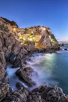 Images Dated 8th December 2012: Manarola village illuminated by the blue light of dusk with its typical pastel colored houses