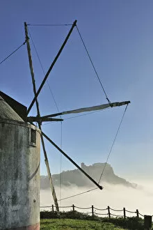 Arrabida Gallery: The medieval castle of Palmela and a windmill in a foggy morning, Portugal