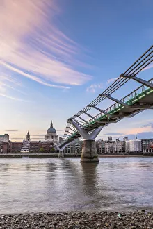 Millennium Bridge and St. Pauls Cathedral at sunset, City of London, London, UK Millennium Bridge and St. Pauls Cathedral at sunset, City of London, London, UK