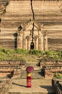 Images Dated 26th December 2015: Mingun, Sagaing region, Myanmar (Burma). Woman with red umbrella looks at the Pahtodawgyi