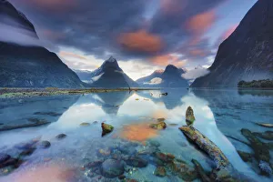 Mitre Peak reflecting in the fjord water at sunrise at Milford Sound in New Zealand Mitre Peak reflecting in the fjord water at sunrise at Milford Sound in New Zealand