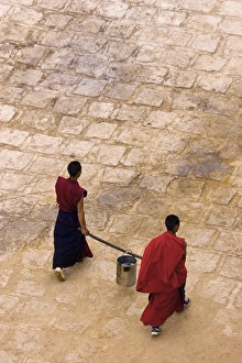 Monks carrying yak butter, Ganden Monastery, Tagtse county, Tibet Monks carrying yak butter, Ganden Monastery, Tagtse county, Tibet