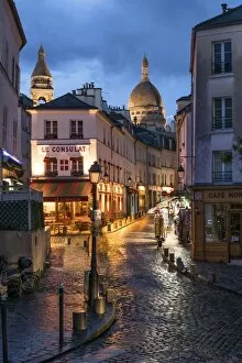 Tourist Gallery: Montmartre at night with illuminated Sacre Coeur Basilica in the background, Paris