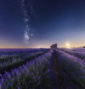 Moonset and milky way over an abandoned farmhouse in the middle of lavenders fields Moonset and milky way over an abandoned farmhouse in the middle of lavenders fields