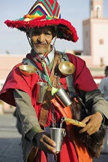 Medina of Marrakesh Gallery: A Moroccan water seller in traditional dress in the Djemaa el Fna