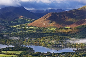 Mountains and woodland form a backdrop to Derwent Water in the Lake District, Cumbria Mountains and woodland form a backdrop to Derwent Water in the Lake District, Cumbria