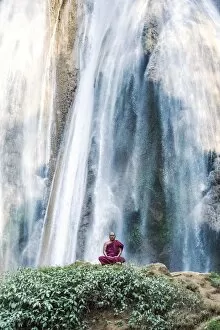 Burma Collection: Myanmar, Mandalay division, Pyin Oo Lwin. Burmese monk meditating under Dattawgyaik Waterfall