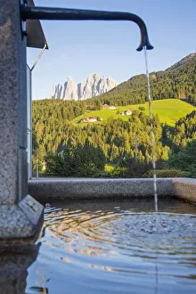 Odle peaks reflected in a fountain, Dolomites, South Tyrol, Trentino Alto Adige, Italy Odle peaks reflected in a fountain, Dolomites, South Tyrol, Trentino Alto Adige, Italy