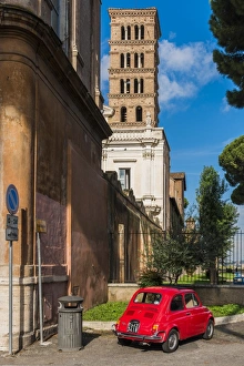 Old Fiat 500 car parked with Basilica dei Santi Bonifacio ed Alessio in the background Old Fiat 500 car parked with Basilica dei Santi Bonifacio ed Alessio in the background