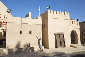An Omani boy jumps to catch a ball in Bahla Fort, Tanuf, Oman An Omani boy jumps to catch a ball in Bahla Fort, Tanuf, Oman