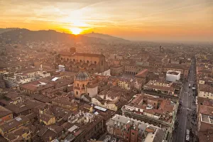 Panorama from Asinelli tower at sunset to Old city of Bologna with San Luca church in the Panorama from Asinelli tower at sunset to Old city of Bologna with San Luca church in the
