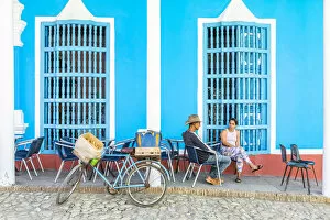People sat outside a restaurant in Trinidad, Sancti Spiritus, Cuba