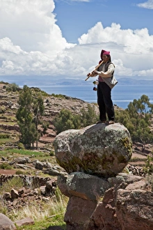 Peru, A Quechua-speaking man plays his flute on Taquile Island Peru, A Quechua-speaking man plays his flute on Taquile Island