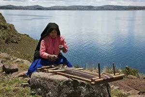 Images Dated 27th December 2009: Peru, A Quechua-speaking woman works her traditional wooden loom on Taquile Island
