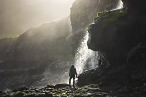 A photographer enjoying a beautiful atmosphere on the coast close to Mikladalur, island of Kalsoy, Faroe Islands A photographer enjoying a beautiful atmosphere on the coast close to Mikladalur, island of Kalsoy, Faroe Islands