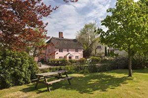 Picnic bench and pretty pink cottage in the village of Winsford, Exmoor National Park Picnic bench and pretty pink cottage in the village of Winsford, Exmoor National Park
