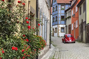 Picturesque cobblestone street with original Volkswagen Beetle car, Rothenburg ob Picturesque cobblestone street with original Volkswagen Beetle car, Rothenburg ob