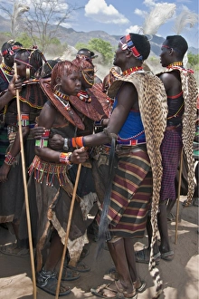 Pokot men, women and girls dancing to celebrate an Atelo ceremony. The Pokot are pastoralists speaking a Southern Pokot men, women and girls dancing to celebrate an Atelo ceremony. The Pokot are pastoralists speaking a Southern