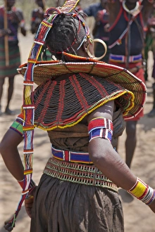 A Pokot woman in traditional attire dances to celebrate an Atelo ceremony A Pokot woman in traditional attire dances to celebrate an Atelo ceremony