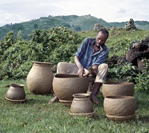 A potter fashions cooking pots by the coil method A potter fashions cooking pots by the coil method