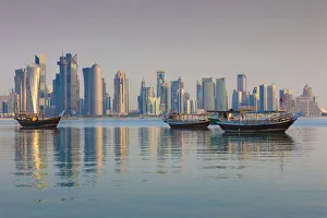 Qatar, Doha, Dhows on Doha Bay with West Bay skyscrapers, dawn Qatar, Doha, Dhows on Doha Bay with West Bay skyscrapers, dawn