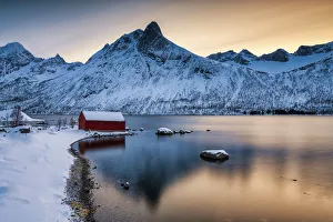 Red Boat Hut & Mountain Peak Reflecting in Bergsbotn Fjord, Senja, Norway Red Boat Hut & Mountain Peak Reflecting in Bergsbotn Fjord, Senja, Norway