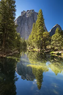Reflection of trees in Merced River by Cathedral Rocks, Yosemite National Park Reflection of trees in Merced River by Cathedral Rocks, Yosemite National Park