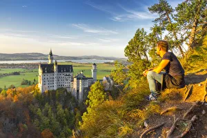 Resting and admiring panorama near Neuschwanstein Castle in Autumn at sunset. Schwangau Resting and admiring panorama near Neuschwanstein Castle in Autumn at sunset. Schwangau