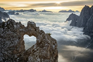 A rocks heart, on a clouds sea, between rock walls. (Dolomites, Italy) A rocks heart, on a clouds sea, between rock walls. (Dolomites, Italy)