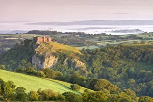 Ruins of Carreg Cennen Castle at dawn in the summer, Brecon Beacons, Carmarthenshire Ruins of Carreg Cennen Castle at dawn in the summer, Brecon Beacons, Carmarthenshire