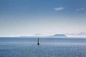 Sailing boat and Fuerteventura, from Playa Blanca, Lanzarote, Canary Islands, Spain Sailing boat and Fuerteventura, from Playa Blanca, Lanzarote, Canary Islands, Spain