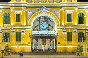 A security guard sits outside of Saigon Central Post Office at night, Ho Chi Minh City A security guard sits outside of Saigon Central Post Office at night, Ho Chi Minh City
