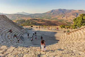 Segesta, Sicily. Tourists visiting the theater of Segesta at sunset Segesta, Sicily. Tourists visiting the theater of Segesta at sunset