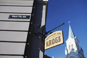 Shop sign and church spire, Riga, Latvia