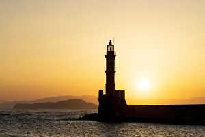 Silhouette of Chania old lighthouse at sunset, Crete island, Greece Silhouette of Chania old lighthouse at sunset, Crete island, Greece