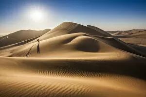 Swakopmund Collection: Single person walking over sand dunes near Swakopmund, Namibia