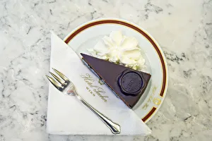 A slice of Original Sacher - Torte cake with whipped cream at Hotel Sacher, Vienna A slice of Original Sacher - Torte cake with whipped cream at Hotel Sacher, Vienna