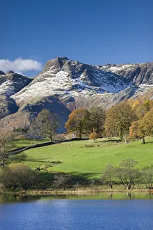 Snow dusted Langdale Pikes viewed from the shores of Loughrigg Tarn, Lake District Snow dusted Langdale Pikes viewed from the shores of Loughrigg Tarn, Lake District