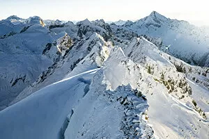 Snowcapped Cime della Bondasca mountains during a winter sunrise, aerial view, Val Bregaglia, Graubunden canton