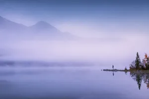 Solitary Person in Mist, Pyramid Lake, Jasper National Park, Alberta, Canada Solitary Person in Mist, Pyramid Lake, Jasper National Park, Alberta, Canada